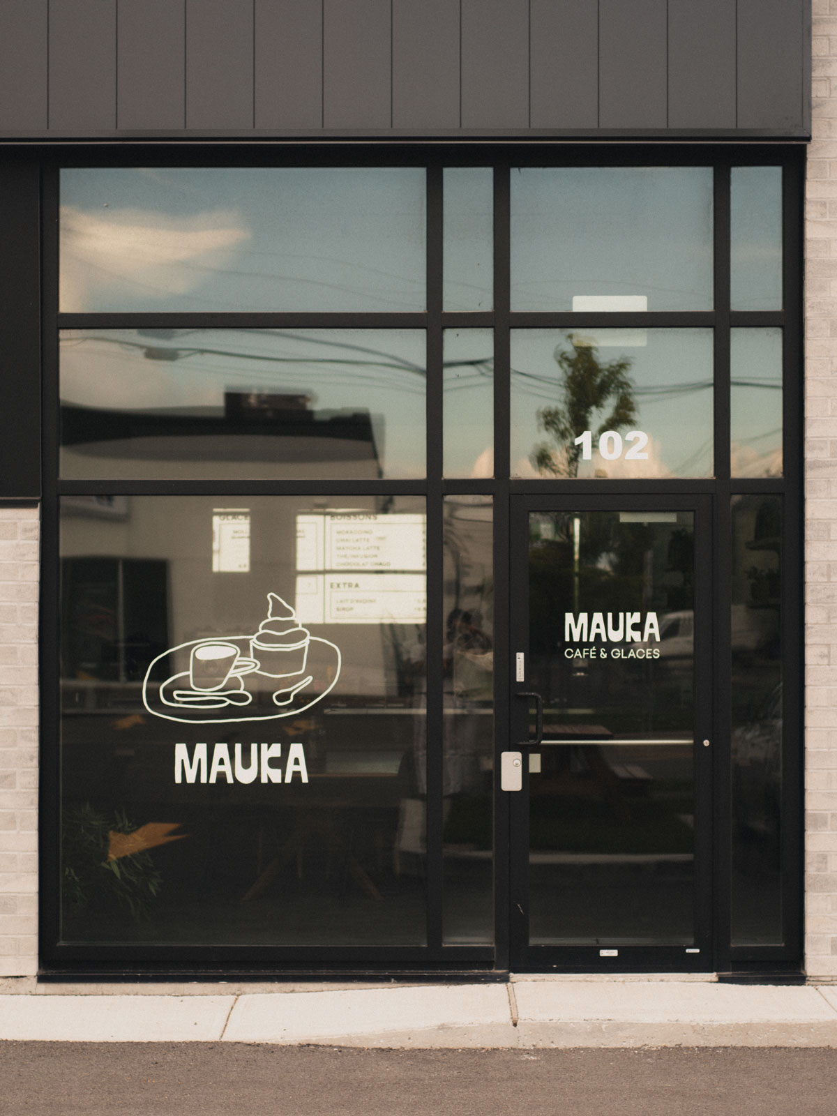 Mauka Café & Glaces storefront with hand-painted window graphics