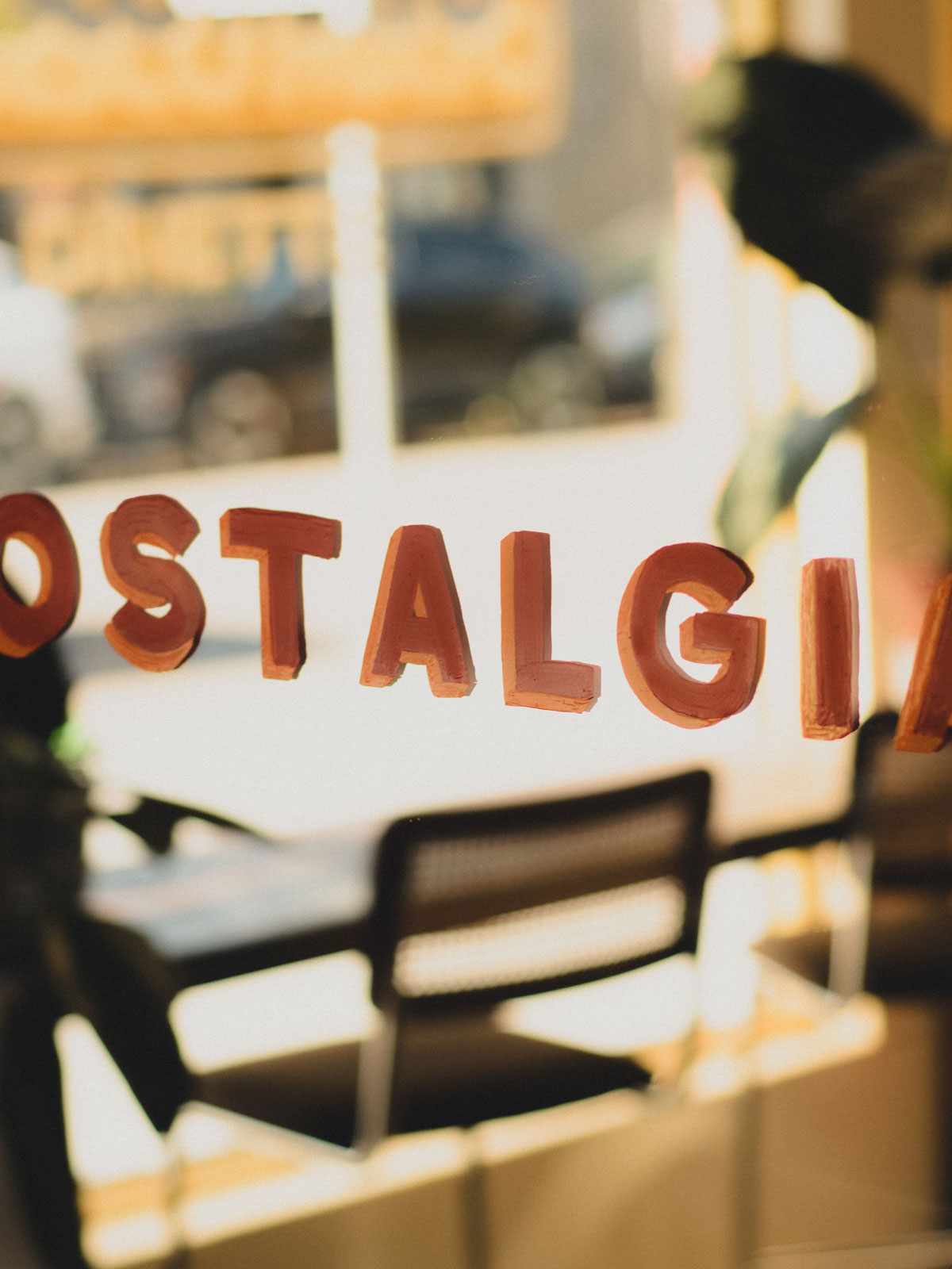 Hand-painted Nostalgia lettering on a café window